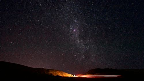 Free Captivating starry night sky over Antofagasta with glowing terrestrial lights. Stock Photo