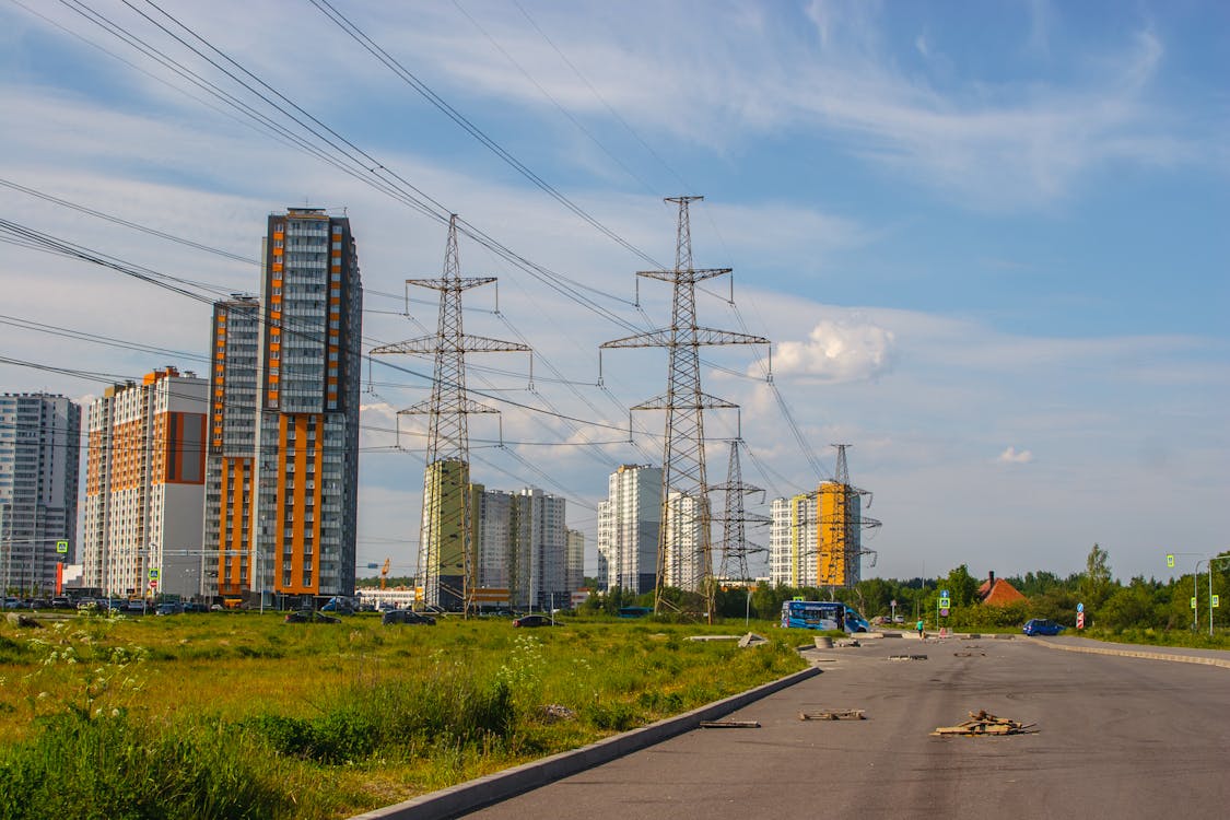 Free Tall Apartment Buildings and Electricity Towers in City  Stock Photo