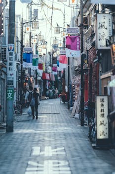 A vibrant street in Tokyo, Japan, adorned with colorful banners and signs, capturing the lively city atmosphere.