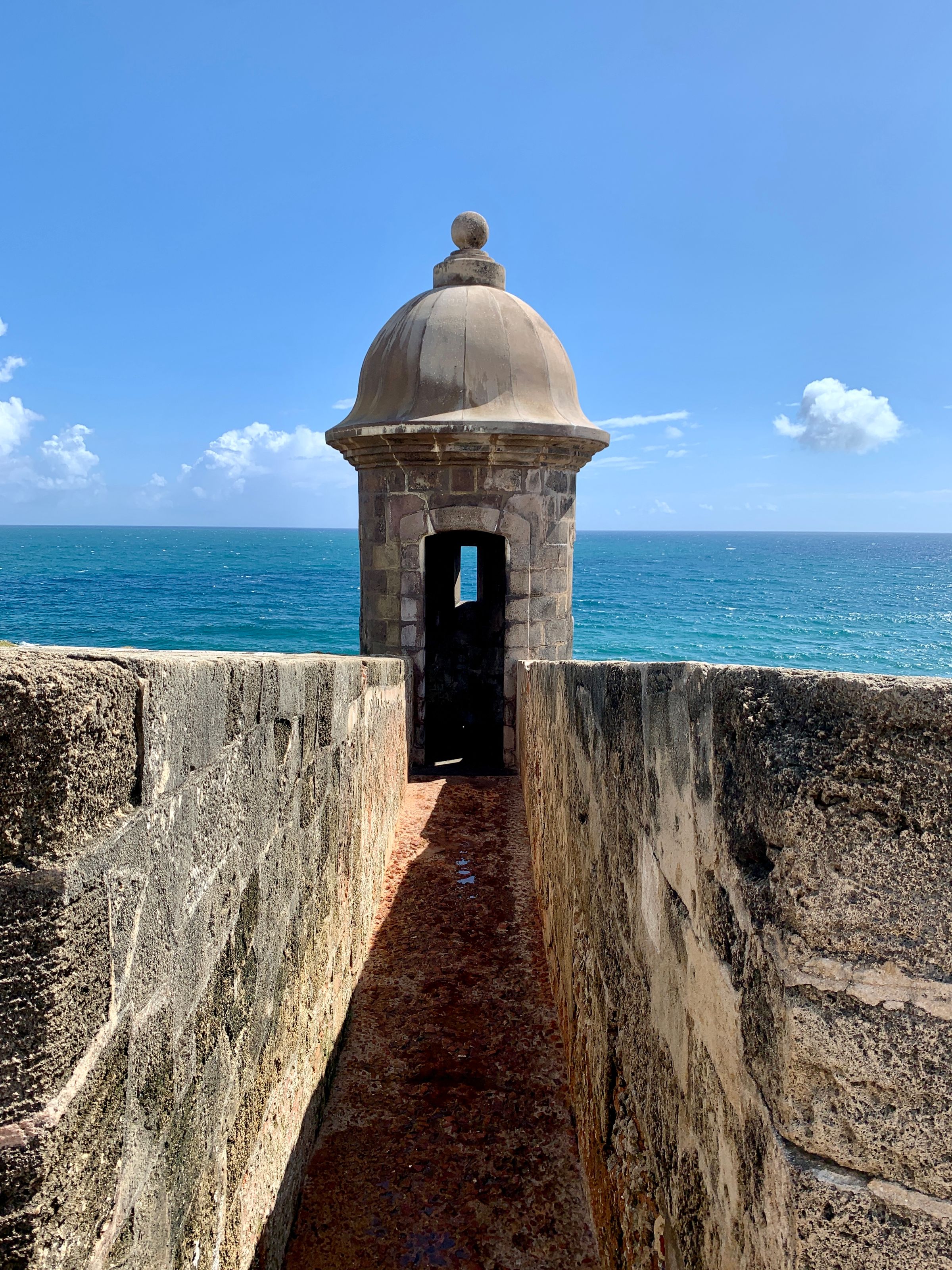 Hero — garita at first light, Old San Juan. Soft morning fog, side angle, no people, warm sunrise, quiet.