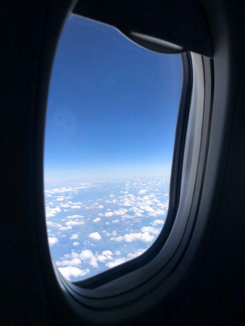 Free A breathtaking view of the sky and clouds from airplane window during flight. Stock Photo