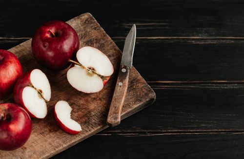 Free Top view of ripe red apples and knife on rustic wooden board, perfect for healthy eating themes. Stock Photo