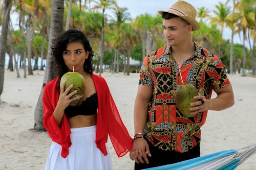 Man And Woman Drinking Fresh Coconut Juice