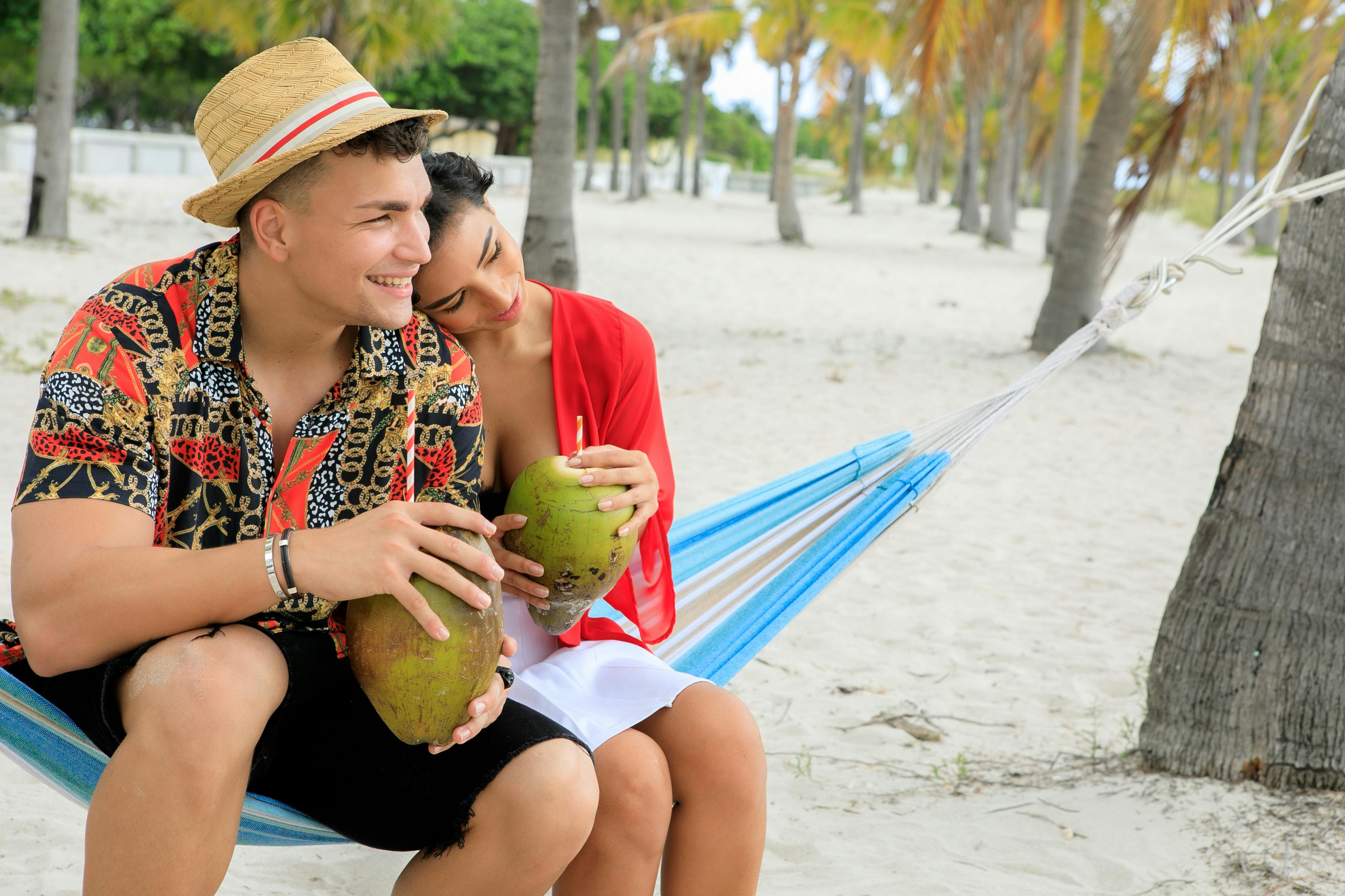 couple in beach holding coconut