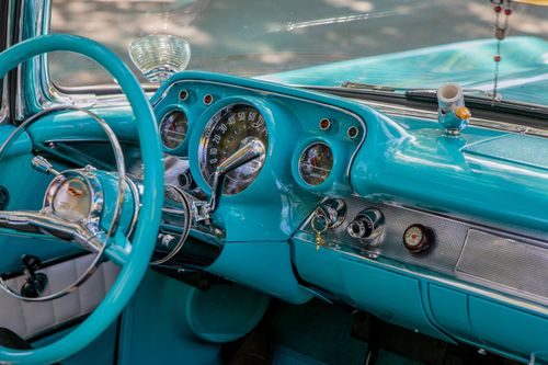 Free Detailed view of a classic car's turquoise interior and retro dashboard. Stock Photo