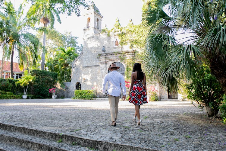 Back View Of A Woman And Man Walking On The Park