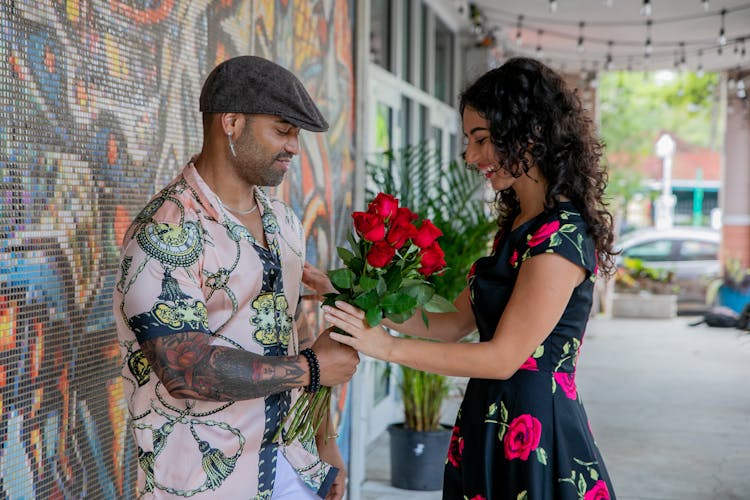 Man Giving Red Roses To The Woman 