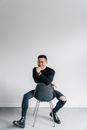 A Man Sitting on a Backward Chair