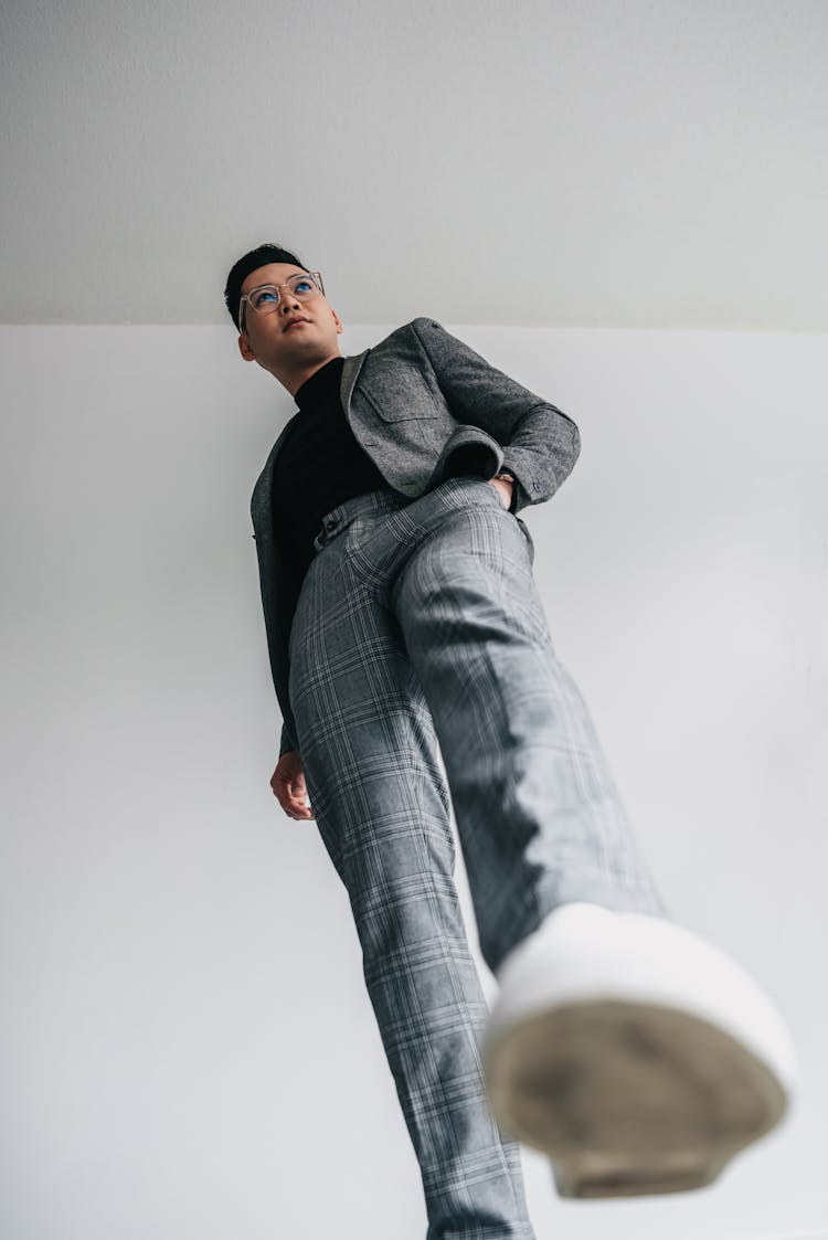 Low-Angle Shot Of A Man Posing With His Hand In His Pocket