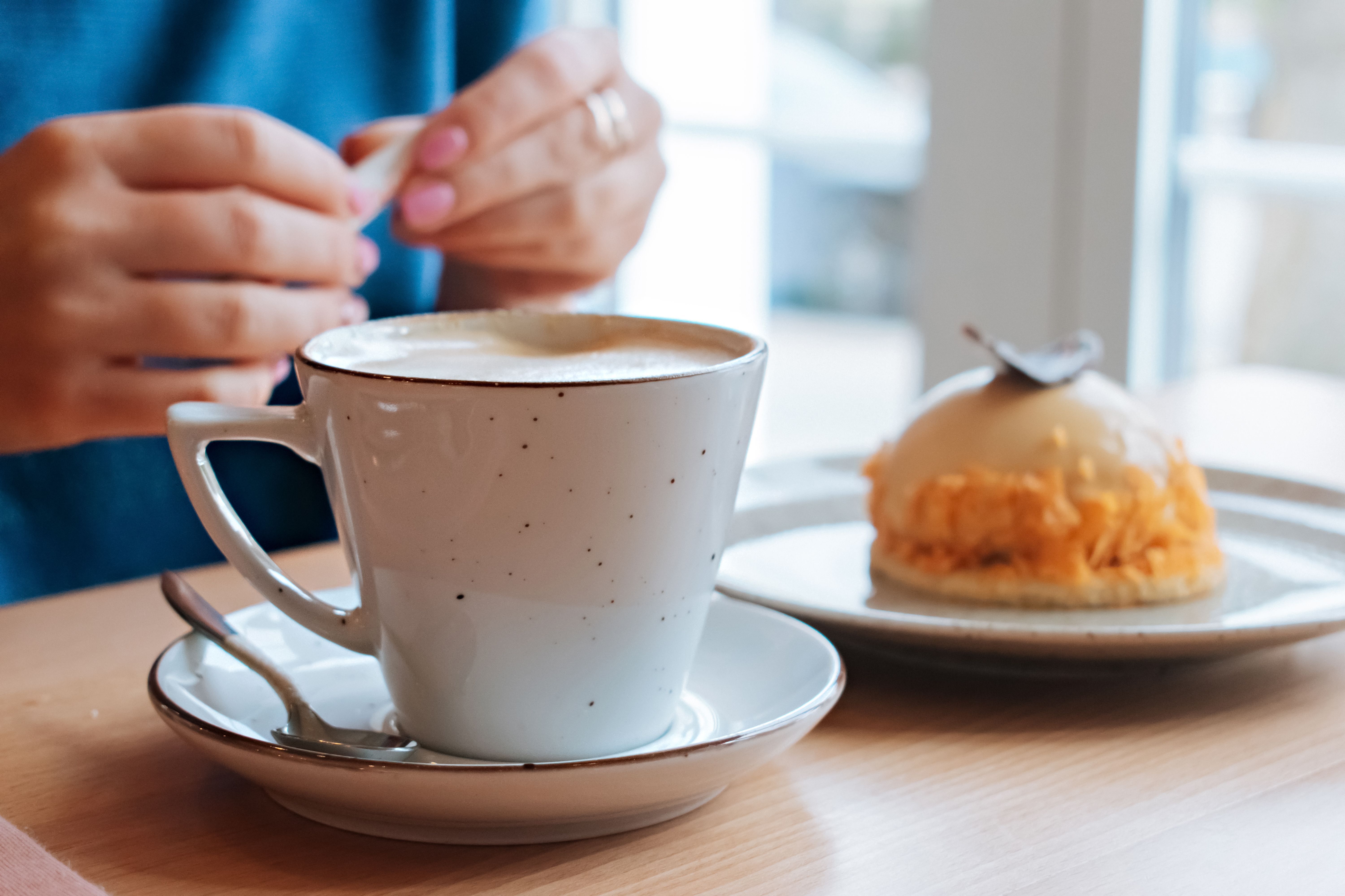 Cup of cappuccino with foamed milk and cinnamon powder