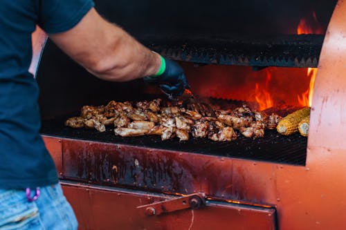Free Cooking of Meat in a Grill  Stock Photo