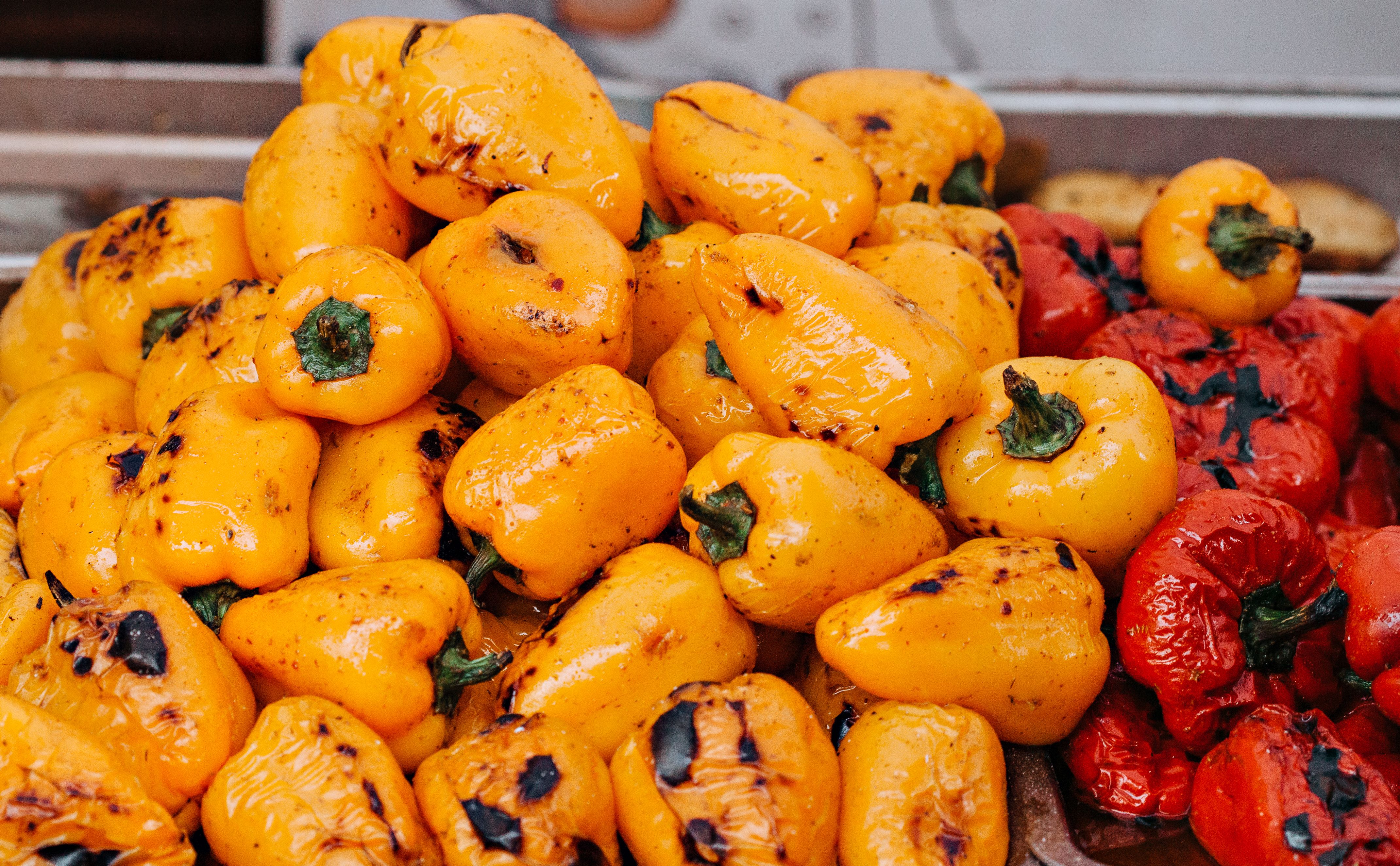Close up of golden grilled vegetables sizzling on barbeque