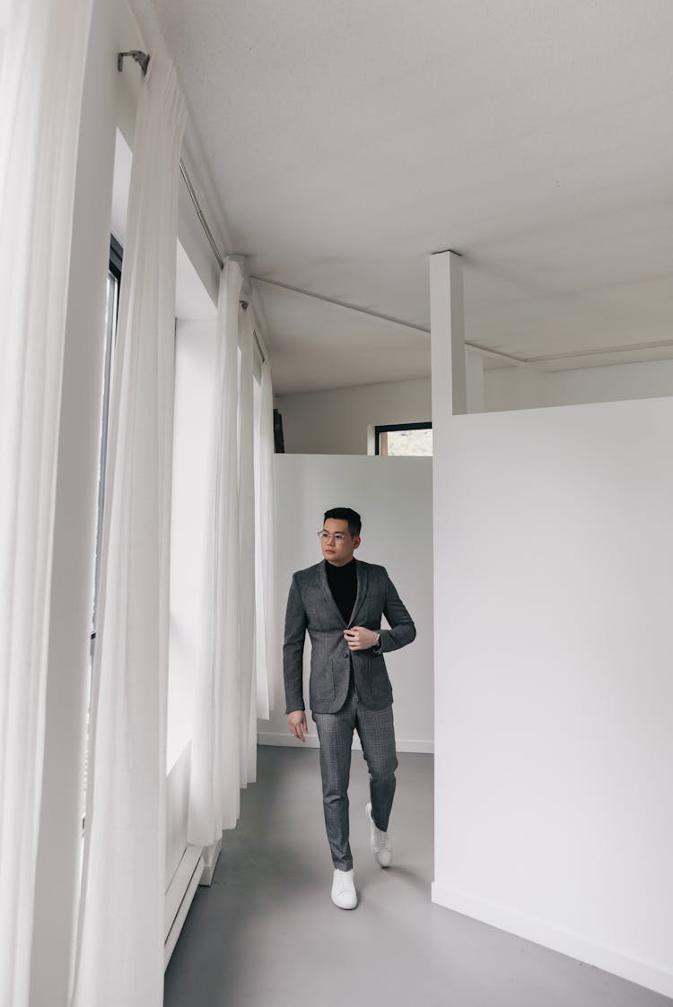 Man Wearing Suit Walking In Hallway