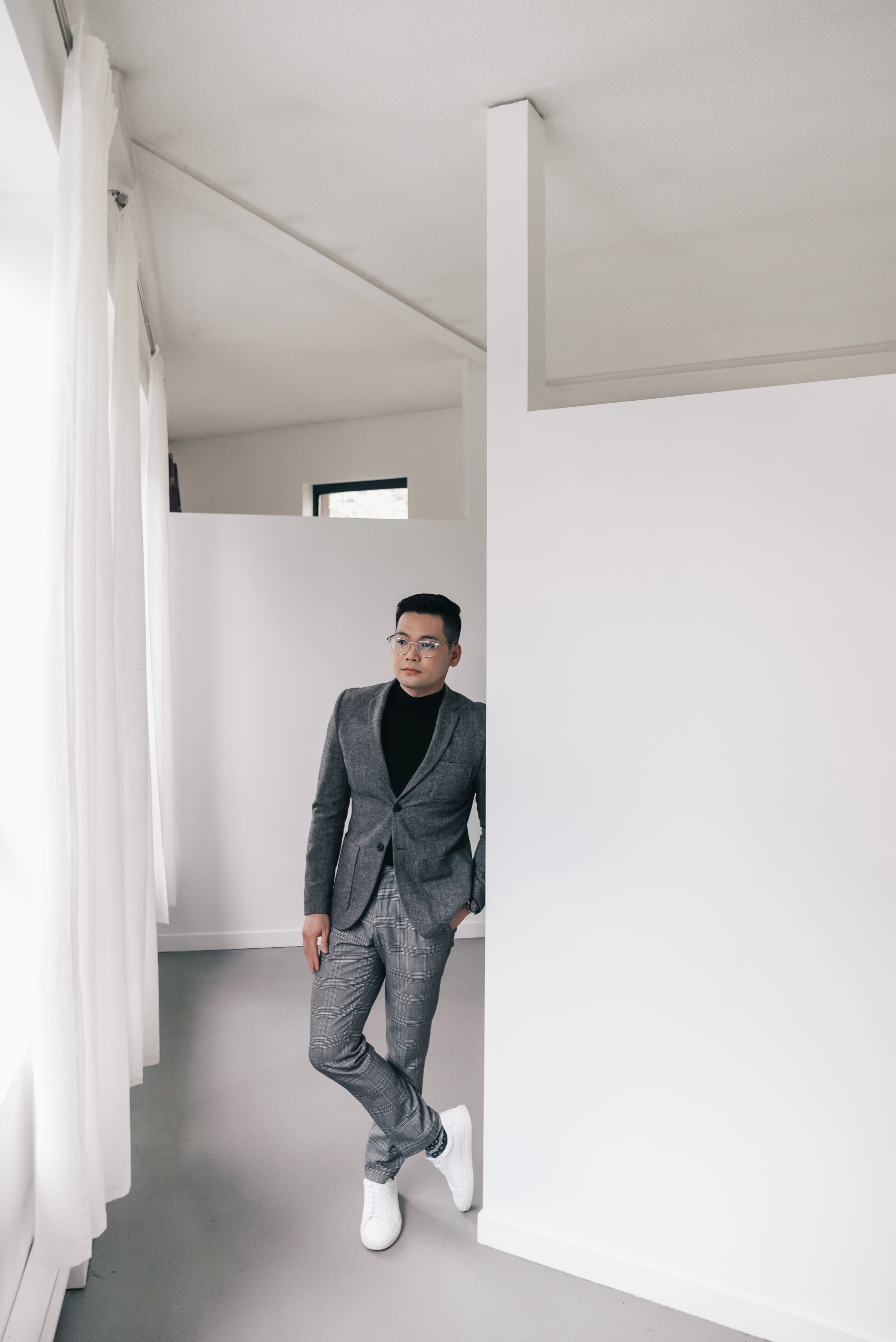 A Man in Suit Standing Beside a Wall · Free Stock Photo