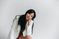 Woman in White Long Sleeve Shirt and Orange Skirt