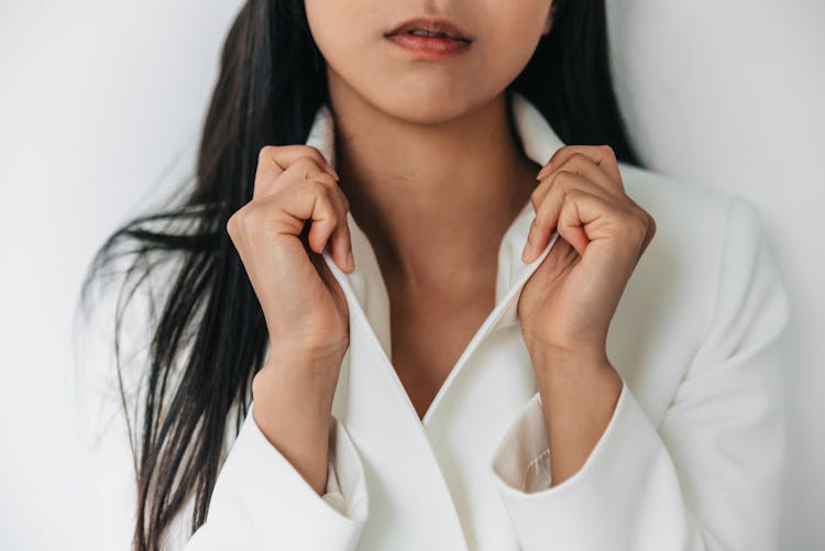 Hands Holding The White Blazer Lapel 