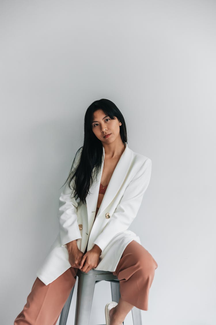 Woman Posing Sitting On Gray Stool Chair 