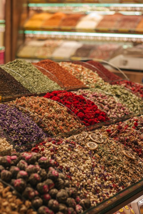 Free A vivid display of assorted spices and herbs in a market, showcasing rich colors and variety for culinary inspiration. Stock Photo