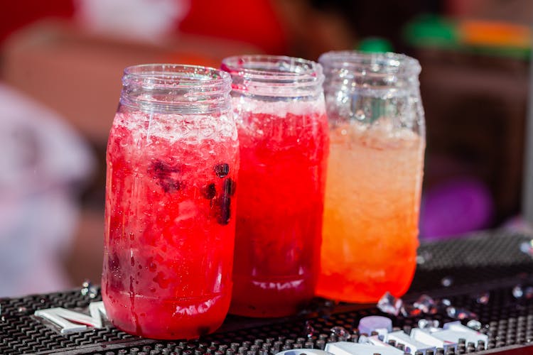 Colored Liquids In Clear Glass Jars 