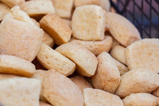 A close-up image highlighting a basket of freshly baked, crispy biscuits.