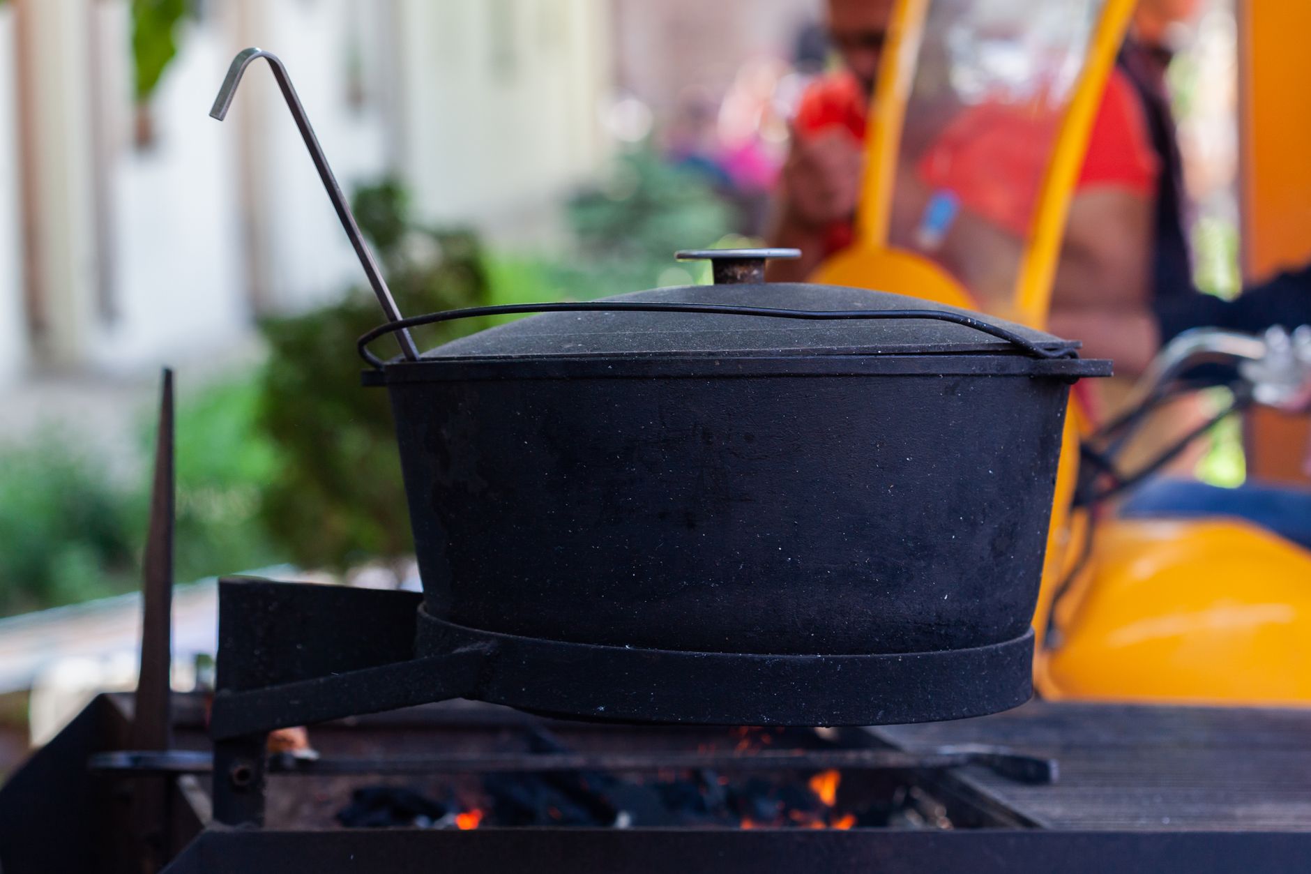 Food cooking on cast iron skillet over campfire