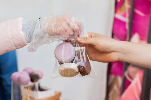 Photo of a Person Getting a Plastic with Cookies