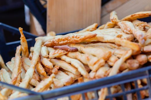 Delicious golden brown breadsticks neatly arranged in a basket, showcasing a perfect snack or appetizer.