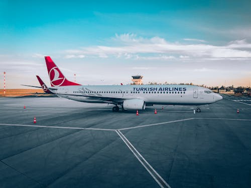 Free White and Red Airplane on the Airport Stock Photo