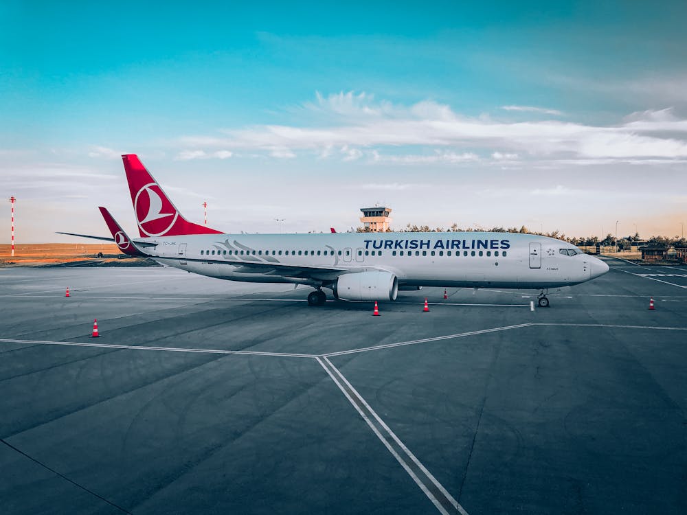 Free White and Red Airplane on the Airport Stock Photo