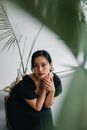 Woman in Black Shirt Sitting on White Chair