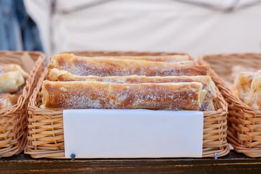 Delicious sweet pastries dusted with powdered sugar, neatly arranged in wicker baskets.