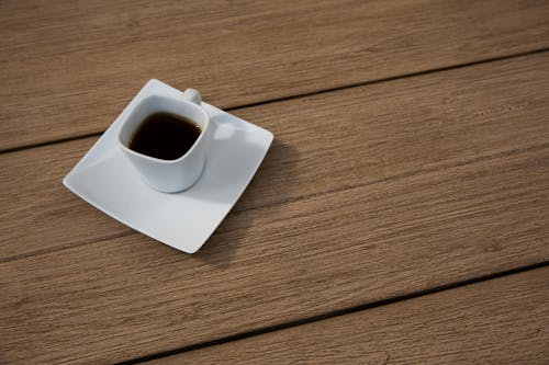 Free Photo of a Saucer with a Hot Beverage on top of a Wooden Surface Stock Photo