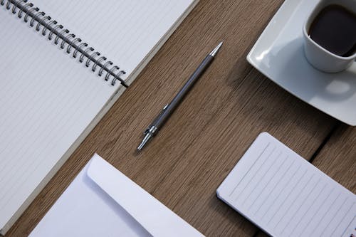 Free Overhead Shot of a Pen Near a Cup of Coffee Stock Photo