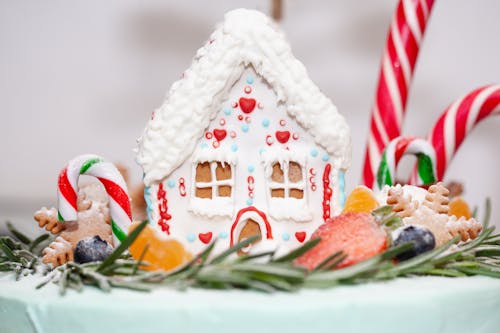 Gingerbread House Surrounded with Fruits and Candies 