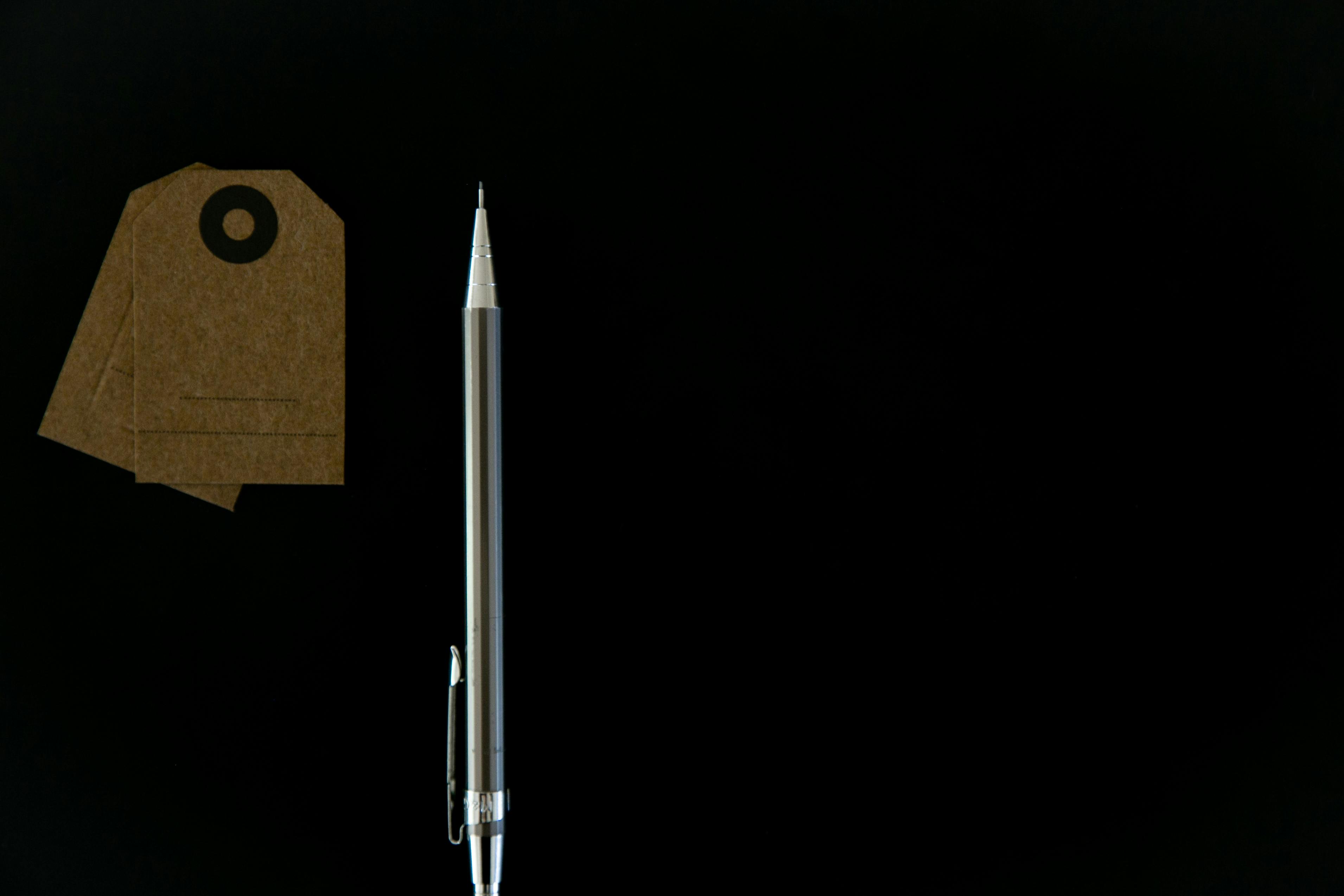 tags beside a mechanical pencil