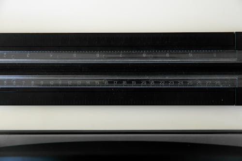 Free A Ruler on a Black Surface Stock Photo