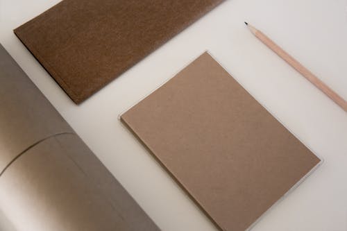 A Pencil and Cardboards on White Desk