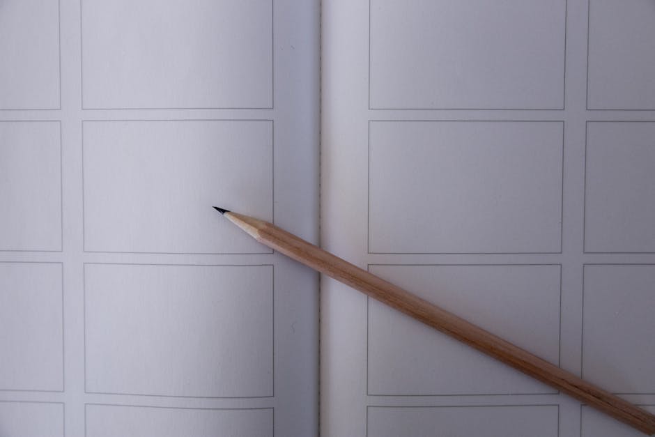 Close-up of a pencil on a storyboard sketch template with blank frames.