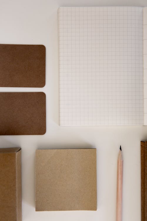 Overhead View of Paper and Pencil on White Desk