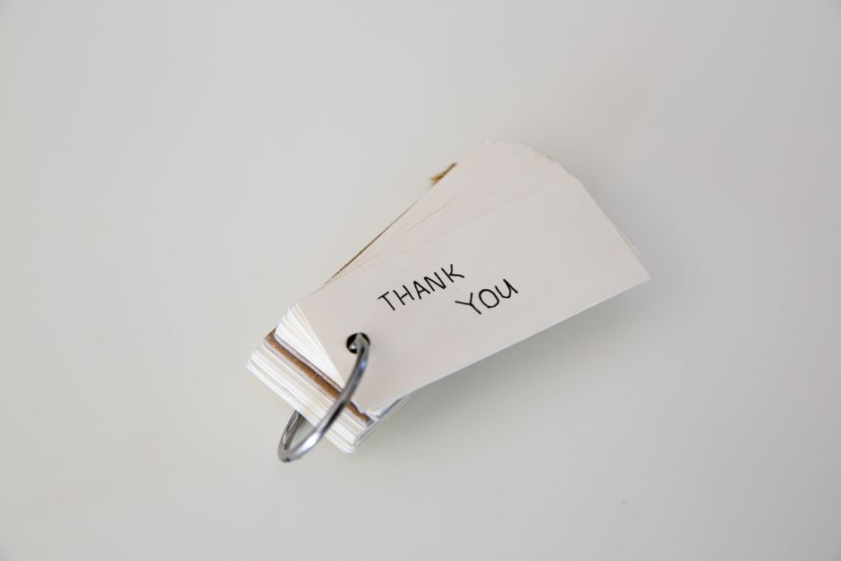 A minimalist thank you card with a ring binder on white background for gratitude messages.