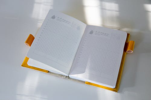 Open Notebook on White Background