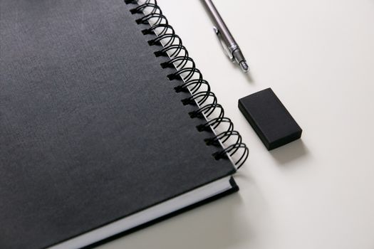 Silver Click Pen on Black Notebook