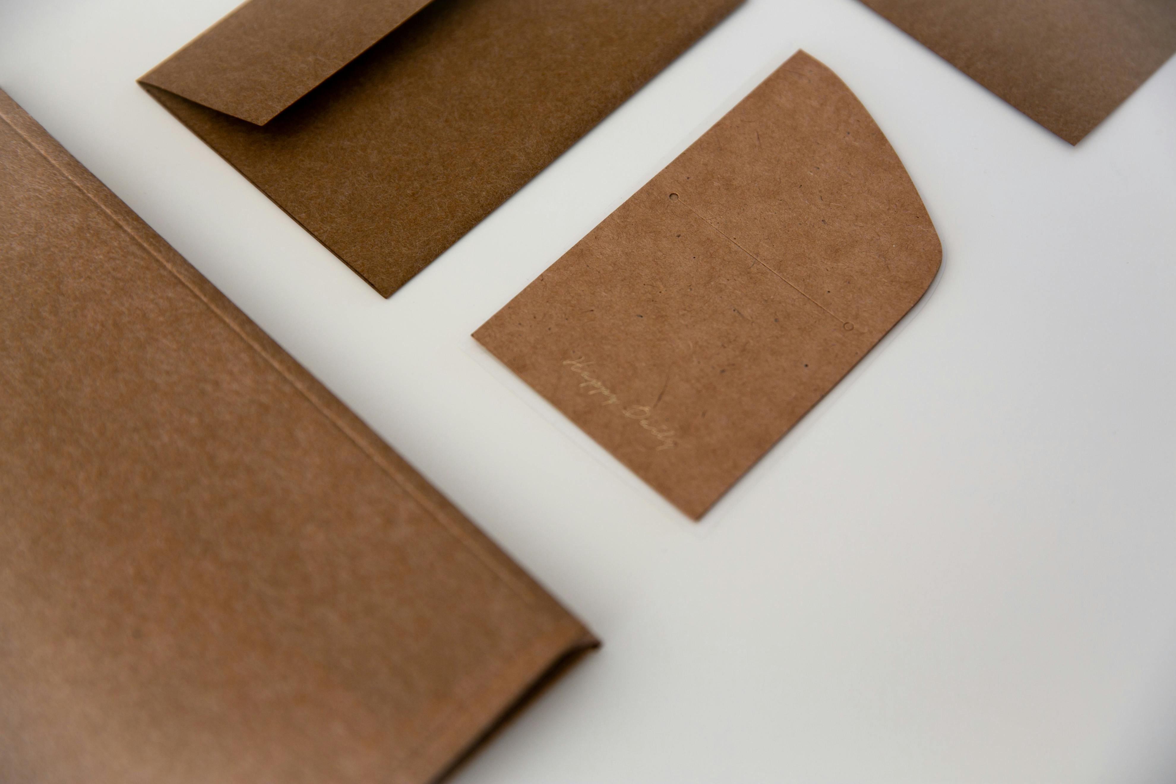 A modern flat lay of brown cardboard envelopes on a clean white background conveying simplicity and eco-friendliness.