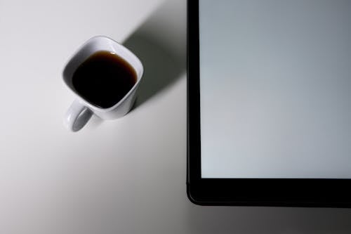 Free Photograph of a Cup of Coffee Near a Tablet Stock Photo
