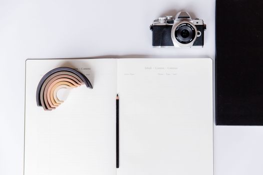 A Notebook Near a Black and Silver Camera
