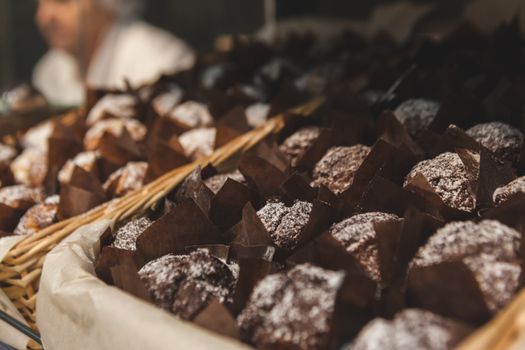 A tempting close-up of chocolate muffins displayed in a basket, perfect for bakery promotions.
