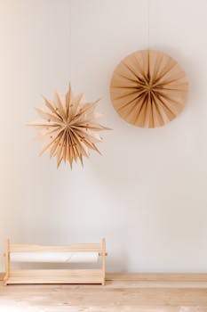 Elegant origami paper stars with a japandi aesthetic hanging on a wooden wall.