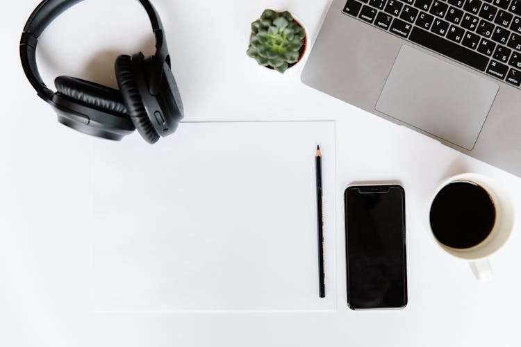 Laptop, Coffee, Cellphone And Headphones