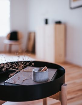 Minimalist Japandi-style decor with a sleek round table indoors.