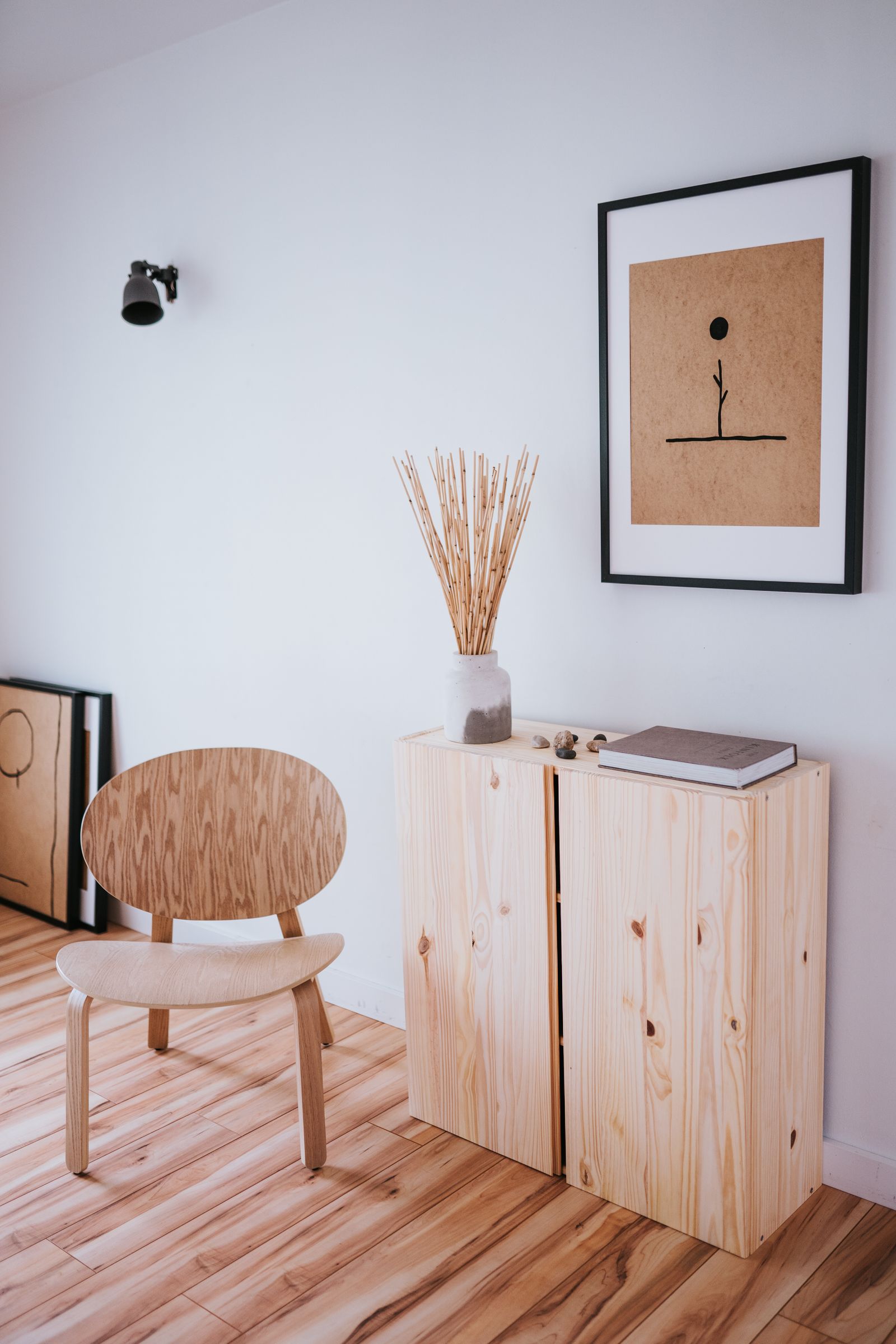 Serene Japandi-style room with wooden furniture and minimalist art